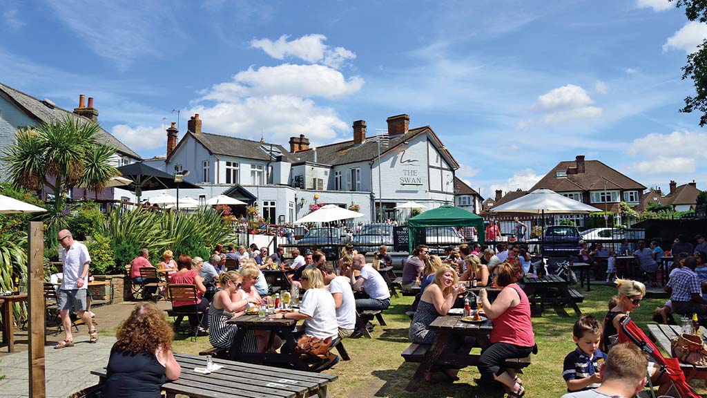 Busy outdoor pub seating area in summer