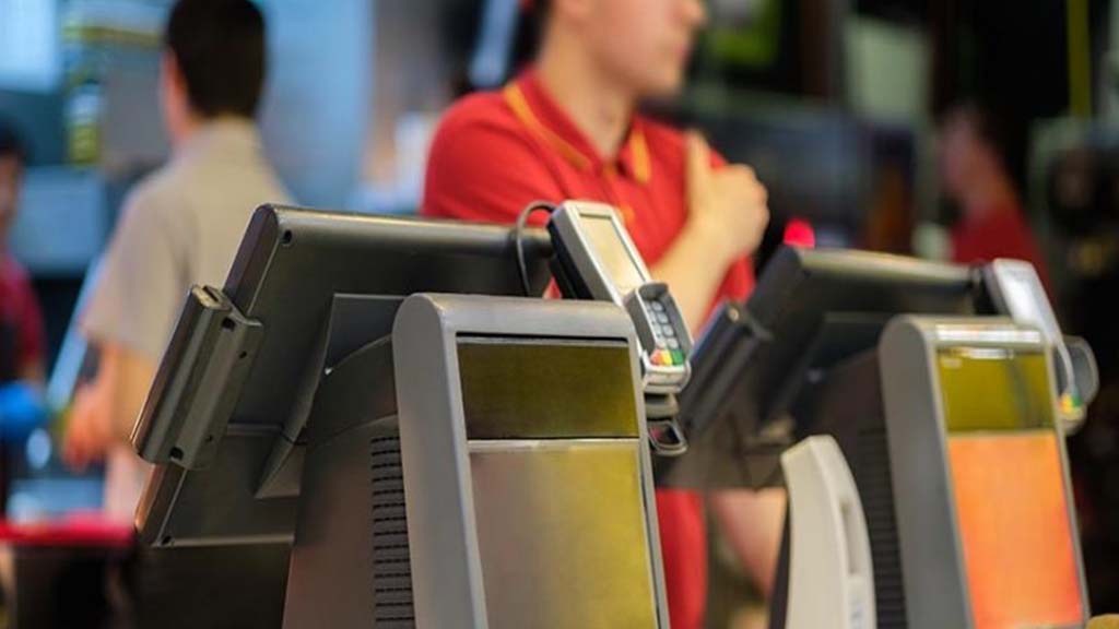 Servers using ICRTouch TouchPoint tills at a fast food counter